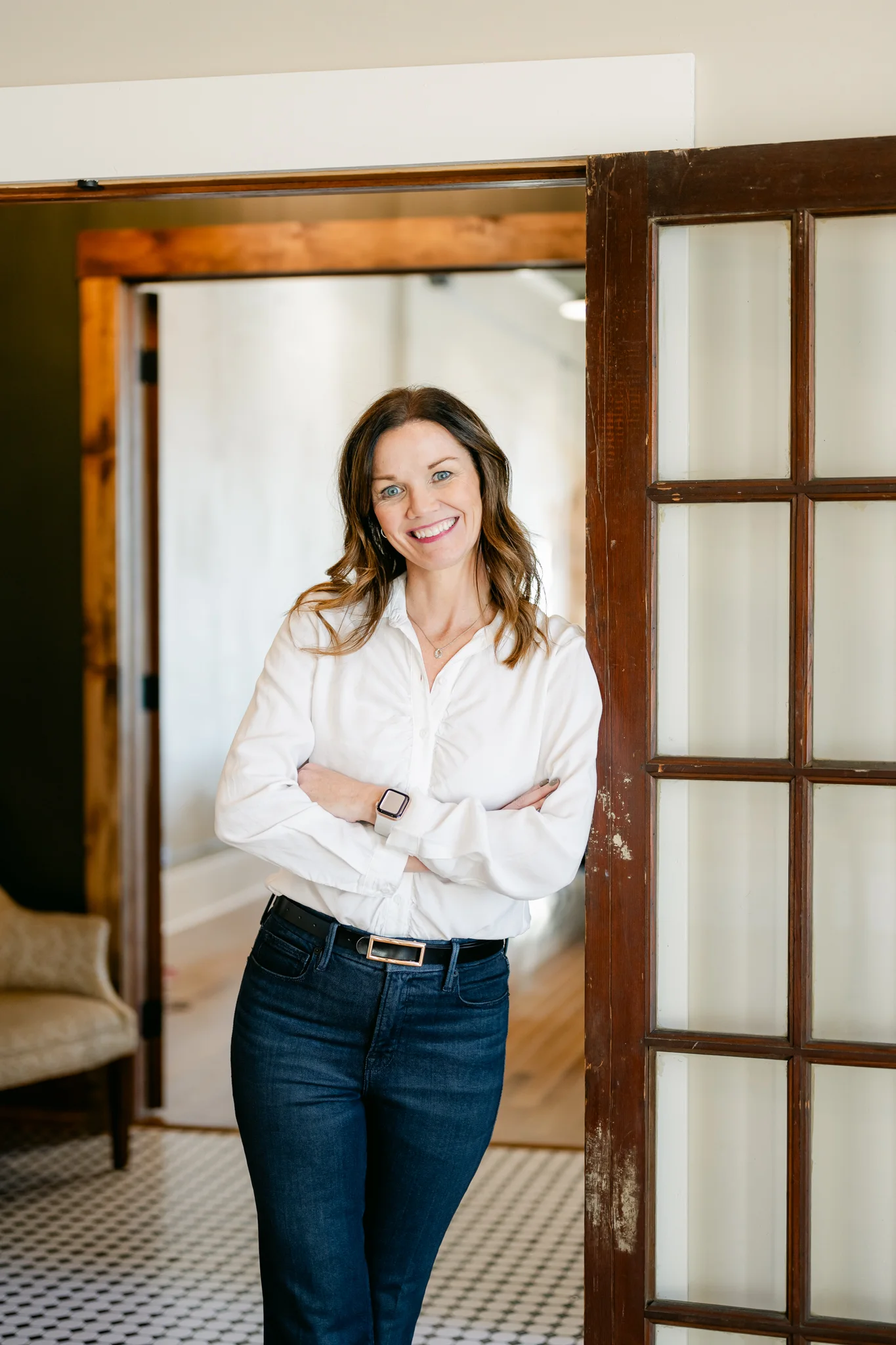 Anne M. Steele standing in the doorway of a local home